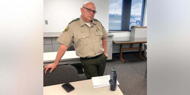 In this Wednesday, June 12, 2019 photo Cedar County, Iowa Sheriff Warren Wethington poses for a portrait at his office in Tipton, Iowa. Wethington has declared that his jail will not book any inmates arrested by police officers in the town of Durant, saying he cannot vouch for the officers' integrity. Wethington issued the directive last month, which applies to anyone arrested by the Durant Police Department. Wethington says one of Durant's three officers has a history of being untruthful and using questionable force and the chief knows this but hired him anyway. (AP Photo/Ryan J. Foley)