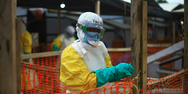 This Tuesday, April, 16, 2019 photo taken in Congo shows an Ebola health worker at a treatment center in Beni, Eastern Congo. Uganda's health ministry said late Tuesday, June 11, 2019 that a 5-year-old Congolese boy who crossed into Uganda has tested positive for Ebola in what is the first cross-border case of the deadly virus since an outbreak started in neighboring Congo last year. (AP Photo/Al-hadji Kudra Maliro, File)