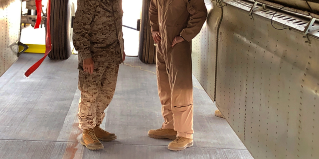 Marine Gen. Frank McKenzie, head of U.S. Central Command, confers with an Air Force officer below the bomb bay of a B-52 bomber on Friday, June 7, 2019 at al-Udeid air base in Qatar. (AP Photo/Robert Burns)