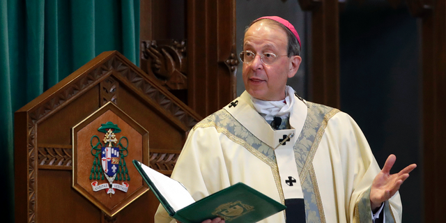 FILE - In this March 28, 2017, file photo, Baltimore Archbishop William Lori leads a funeral Mass in Baltimore. On Wednesday, June 5, 2019, Lori released a report on an investigation into former Roman Catholic Bishop Michael Bransfield, in West Virginia, that found a "consistent pattern" of sexual innuendo and suggestive comments and actions toward subordinates. (AP Photo/Patrick Semansky, File)