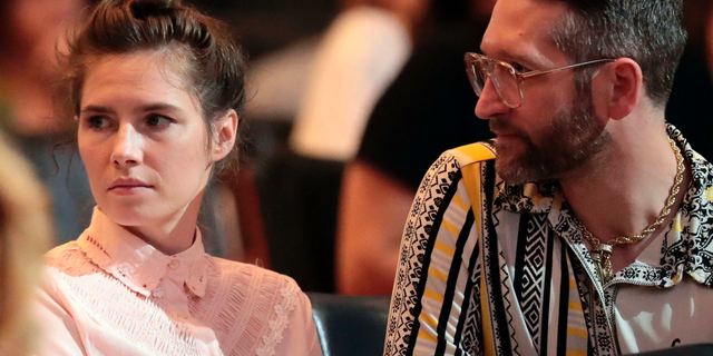 Amanda Knox and her fiancee Christopher Robinson attend a conference during a Criminal Justice Festival at the University of Modena, Italy, Friday, June, 2019. (Elisabetta Baracchi/ANSA via AP)