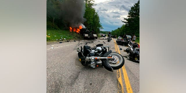 This photo provided by Miranda Thompson shows the scene where several motorcycles and a pickup truck collided on a rural, two-lane highway Friday, June 21, 2019 in Randolph, N.H. (Associated Press)