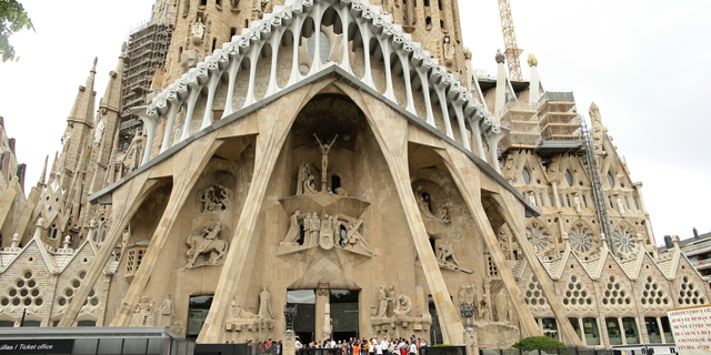 FILE - In this Sunday, Aug. 20, 2017 file photo, dignitaries leave after a Mass at Barcelona's Sagrada Familia Basilica for the victims of the terror attacks, in Barcelona, Spain. Barcelona’s breathtaking La Sagrada Familia Basilica designed by architect Antoni Gaudi has finally received its official construction permit over 130 since the placement of its first stone. Barcelona’s town hall announced on Friday, June 7, 2019 that after negotiations with the church’s builders it had granted them a work permit through 2026. (AP Photo/Manu Fernandez, file)