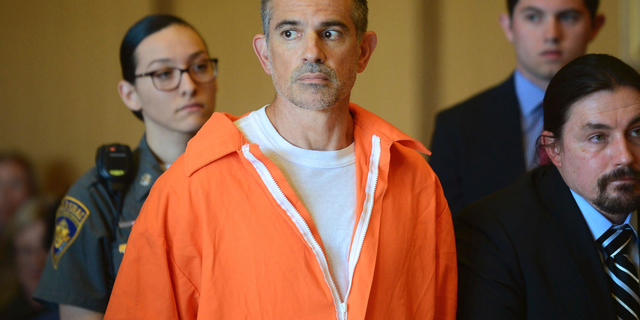 Fotis Dulos stands during a hearing at Stamford Superior Court, Tuesday, June 11, 2019 in Stamford, Conn. Fotis Dulos, and his girlfriend, Michelle Troconis, have been charged with evidence tampering and hindering prosecution in the disappearance of his wife Jennifer Dulos. The mother of five has has been missing since May 24. (Erik Trautmann/Hearst Connecticut Media via AP, Pool)