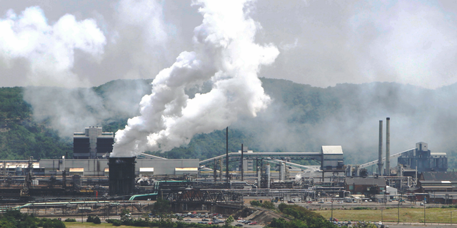 FILE- This file photo from July 14, 2010 shows smoke pouring from the United States Steel Corp.'s Clairton Coke Works in Clairton, Pa. A fire at U.S. Steel's massive coke plant outside Pittsburgh knocked a key pollution control system offline Monday, June 17, 2019. It triggered a health warning as officials monitored the air around the plant for signs of a release of toxic sulfur dioxide. It was the second fire since December at the coke works, the largest facility of its kind in the United States. The plant turns coal into coke, one of the raw materials of steel. (AP Photo/Keith Srakocic, File)