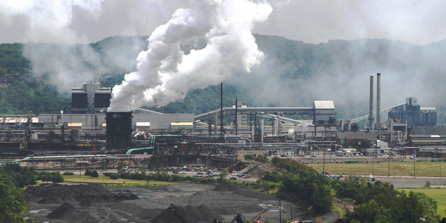FILE- This file photo from July 14, 2010 shows smoke pouring from the United States Steel Corp.'s Clairton Coke Works in Clairton, Pa. A fire at U.S. Steel's massive coke plant outside Pittsburgh knocked a key pollution control system offline Monday, June 17, 2019. It triggered a health warning as officials monitored the air around the plant for signs of a release of toxic sulfur dioxide. It was the second fire since December at the coke works, the largest facility of its kind in the United States. The plant turns coal into coke, one of the raw materials of steel. (AP Photo/Keith Srakocic, File)