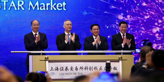 From left; Yi Huiman, Chairman of China Securities Regulatory Commission, Chinese Vice Premier Liu He, Shanghai Party Secretary Li Qiang, Shanghai mayor and Ying Yong applaud during a ceremony for the launch of the SSE STAR Market, previously referred to as the Shanghai Science and Technology Innovation Board, in Shanghai, Thursday, June 13, 2019. Chinese media say the country's top trade negotiator has told a forum in Shanghai that "external pressures" can help the economy. (Chinatopix via AP)