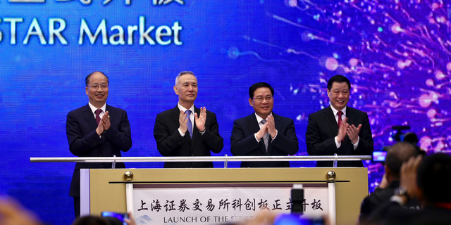 From left; Yi Huiman, Chairman of China Securities Regulatory Commission, Chinese Vice Premier Liu He, Shanghai Party Secretary Li Qiang, Shanghai mayor and Ying Yong applaud during a ceremony for the launch of the SSE STAR Market, previously referred to as the Shanghai Science and Technology Innovation Board, in Shanghai, Thursday, June 13, 2019. Chinese media say the country's top trade negotiator has told a forum in Shanghai that "external pressures" can help the economy. (Chinatopix via AP)