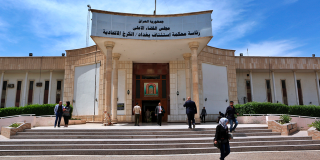 In this Sunday, May 5, 2019 file photo, people walk outside Iraqi Criminal Court in Baghdad's Karkh district, Iraq.