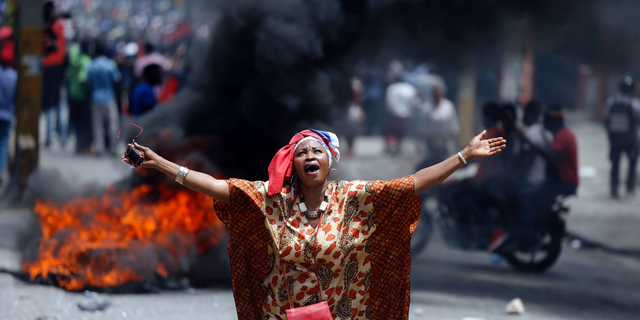 A protester yells anti-government slogans in Port-au-Prince, Haiti, Sunday, June 9, 2019. Protesters denouncing corruption paralyzed much of the capital as they demanded the removal of President Jovenel Moise. (AP Photo/Dieu Nalio Chery)