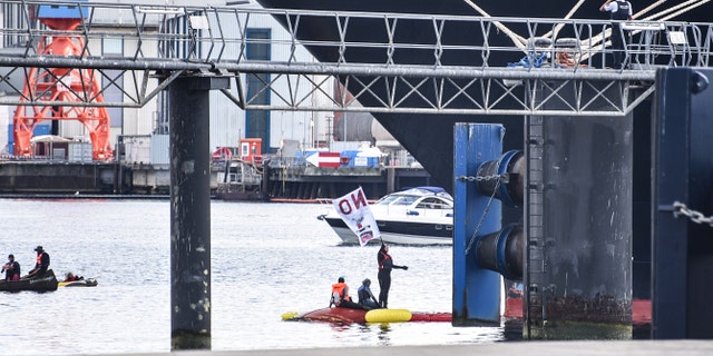 Protesters used small boats to prevent the larger ship from leaving the port.