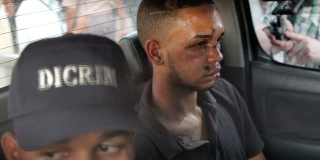 Eddy Vladimir Féliz Garcia, in custody in connection with the shooting of former Boston Red Sox slugger David Ortiz, is transferred by police to court in Santo Domingo, Dominican Republic, (AP Photo/Roberto Guzman)
