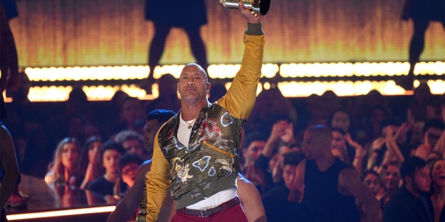 Dwayne Johnson, also known as The Rock, accepts the generation award at the MTV Movie and TV Awards on Saturday, June 15, 2019, at the Barker Hangar in Santa Monica, Calif. (Photo by Chris Pizzello/Invision/AP)