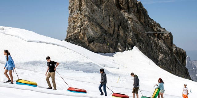 Tourists enjoy the summer temperatures on the Titlis mountain, on Wednesday, June 26, 2019, near Engelberg, Switzerland. All over Europe is hit by a heatwave.