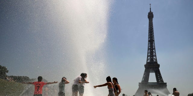 Youngsters cool off at the Trocadero public fountain in Paris, Wednesday, June 26, 2019.