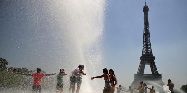 Youngsters cool off at the Trocadero public fountain in Paris, Wednesday, June 26, 2019.