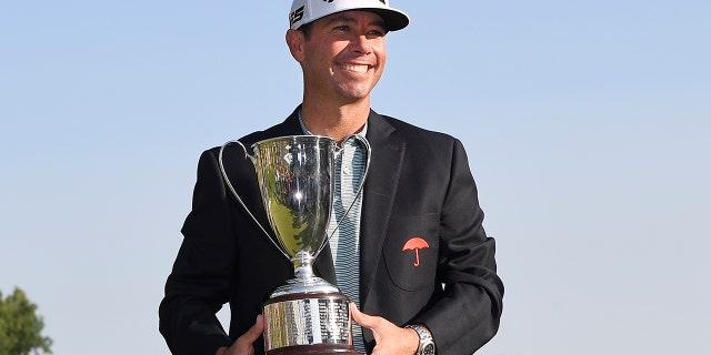 Chez Reavie, winner of the Travelers Championship golf tournament poses with the trophy, Sunday, June 23, 2019, in Cromwell, Conn. (AP Photo/Jessica Hill)