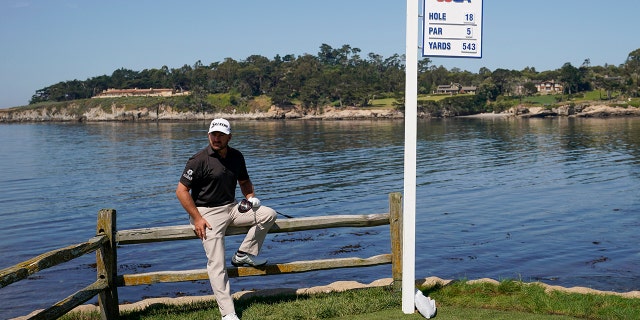 Graeme McDowell, of Northern Ireland, poses for a picture on the 18th hole during a practice round for the U.S. Open Championship golf tournament Tuesday, June 11, 2019, in Pebble Beach, Calif. (AP Photo/David J. Phillip)