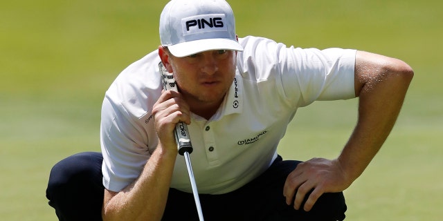 Nate Lashley eyes his putt on the 18th green during the first round of the Rocket Mortgage Classic golf tournament, Thursday, June 27, 2019, in Detroit. (AP Photo/Carlos Osorio)