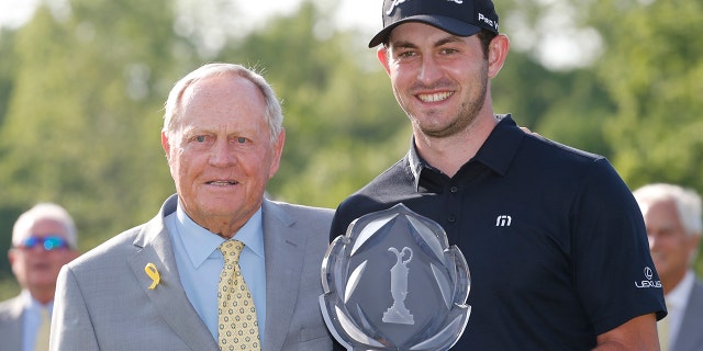 Jack Nicklaus, left, presents Patrick Cantlay with the trophy after Cantlay won the Memorial golf tournament Sunday, June 2, 2019, in Dublin, Ohio. (AP Photo/Jay LaPrete)