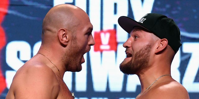Boxers Tyson Fury, left, and Tom Schwarz face off during a ceremonial weigh-in at MGM Grand Garden Arena on June 14, 2019 in Las Vegas. (Getty Images)