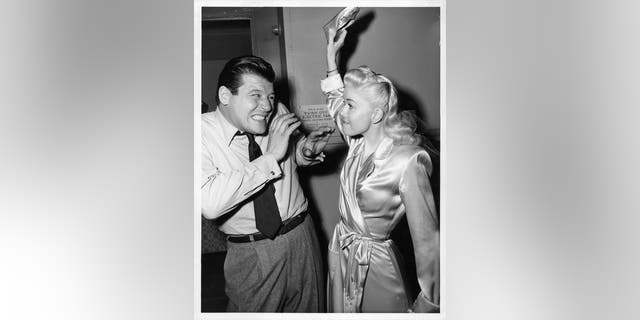 Jack Carson winces as Doris Day is about to hit him with her shoe off camera from the film "My Dream is Yours," circa 1949.<br>
(Photo by Warner Brothers/Getty Images)