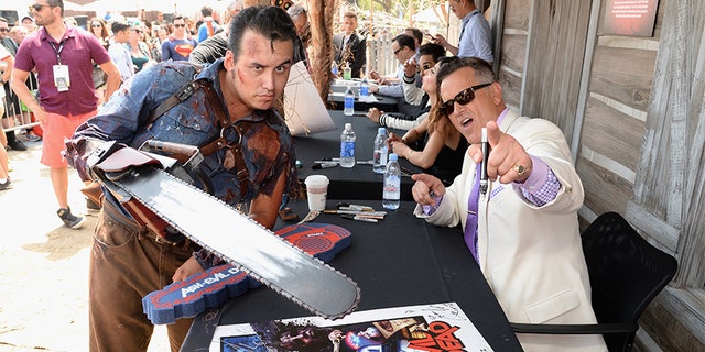 Actor Bruce Campbell with fan attends the "Ash vs Evil Dead" autograph signing during Comic-Con International 2016 on July 23, 2016, in San Diego, Calif. (Photo by Michael Kovac/Getty Images for STARZ)