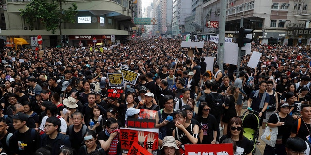 Tens of thousands of protesters march through the streets as they continue to protest an extradition bill, Sunday, June 16, 2019, in Hong Kong.