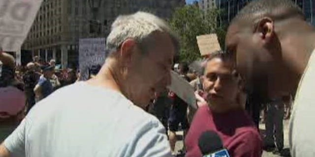 Lawrence Jones confronting two men who made racist remarks to him Saturday at an anti-Trump rally in Lower Manhattan.