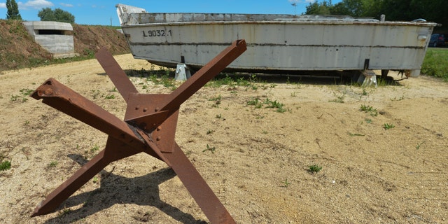 A Czech hedgehog anti-tank obstacle and the landing craft, vehicle, personnel (LCVP) or Higgins boat used during Operation Overlord on D-Day, seen outside Normandy Victory Museum in La Fourchette near Carentan, just a few days ahead of the 75th Anniversary of D-Day. On Saturday, June 1, 2019, in La Fourchette, Carentan, Normandy, France. (Photo by Artur Widak/NurPhoto via Getty Images)