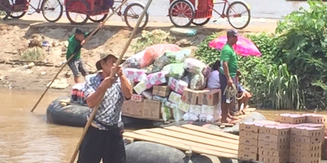 Dozens of rafts cross the Suchiate River carrying locals mostly shopping in Mexico for food, beer and appliances. They take the rafts to avoid tariffs on the bridge and customs officials.