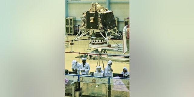 Indian Space Research Organization (ISRO) scientists work on the orbiter vehicle of Chandrayaan-2, India's first Moon lander and rover mission, in Bangalore.