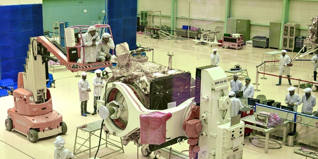 Scientists work on the Chandrayaan-2 orbiter vehicle in Bangalore on June 12, 2019.
