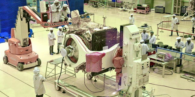 Scientists work on the Chandrayaan-2 orbiter vehicle in Bangalore on June 12, 2019.