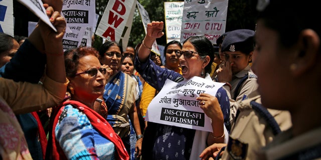 Left-wing activists shout slogans as they protest against deaths of more than 100 children due to encephalitis in the Indian state of Bihar, in New Delhi, India.