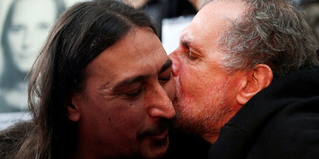 Javier Matias Darroux Mijalchuk, son of Elena Mijalchuk and Juan Manuel Darroux, who disappeared during Argentina's former 1976-1983 dictatorship, is comforted by his uncle, Roberto Mijalchuk during a news conference in Buenos Aires, Argentina June 13, 2019. REUTERS/Agustin Marcarian - RC1CB4B3C300