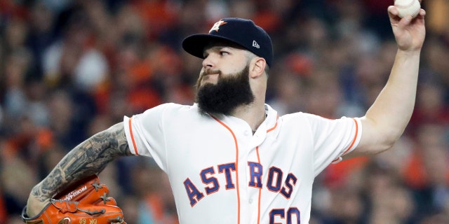 FILE - In this Oct. 16, 2018, file photo, Houston Astros starting pitcher Dallas Keuchel throws against the Boston Red Sox during the first inning in Game 3 of a baseball American League Championship Series in Houston. Pitchers Dallas Keuchel and Craig Kimbrel, the last two top free agents on the market, can sign starting Monday, June 3, 2019, with their new teams having to forfeit amateur draft picks as compensation. Both turned down $17.9 million qualifying offers in November, Keuchel from Houston and Kimbrel from the World Series champion Boston Red Sox. (AP Photo/David J. Phillip, File)