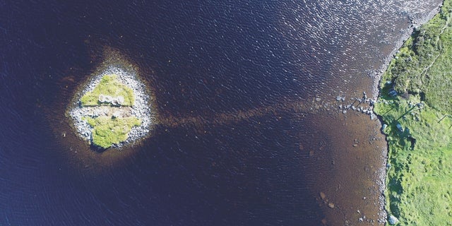 A bird's-eye view of Loch Bhorgastail, an islet that was clearly human-made with boulders.