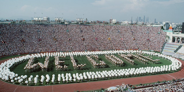 Performers spell out Welcome on the stadium infield during the opening ceremony for the XXIII Olympic Games on 28 July 1984 at the Los Angeles Memorial Coliseum in Los Angeles, California, United States. (Photo by Steve Powell/Allsport//Getty Images)