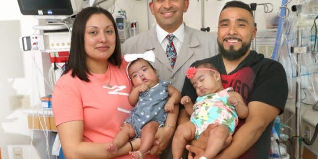 The girls, pictured with their parents and Dr. Aimen Shaaban, were finally reunited Thursday for the first time since their December birth.