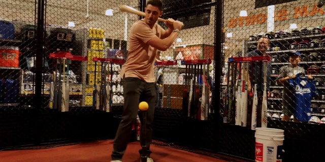 Cody Bellinger takes a few swings in the cage at DICK'S Sporting Goods in Tustin, Calif.