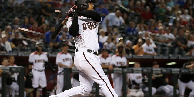 Arizona Diamondbacks' Eduardo Escobar watches the flight of his three-run home run against the Los Angeles Dodgers during the first inning of a baseball game Wednesday, June 26, 2019, in Phoenix. (AP Photo/Ross D. Franklin)