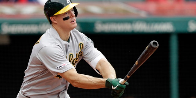 FILE - In this May 22, 2019, file photo, Oakland Athletics' Nick Hundley watches his ball after hitting a one-run double off Cleveland Indians relief pitcher Tyler Clippard in the seventh inning of a baseball game in Cleveland. Five years ago, Hundley visited Children’s Hospital of Wisconsin and met a young man named Zach who sure needed a lift as he fought his battle with leukemia. (AP Photo/Tony Dejak, File)
