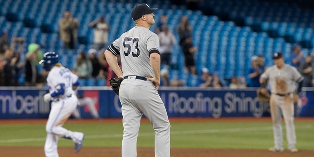 New York Yankees pitcher Zack Britton commented on David Oritz's shot. (Fred Thornhill / The Canadian Press via AP)