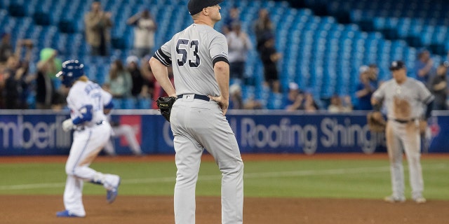 New York Yankees pitcher Zack Britton commented on David Oritz's shot. (Fred Thornhill / The Canadian Press via AP)