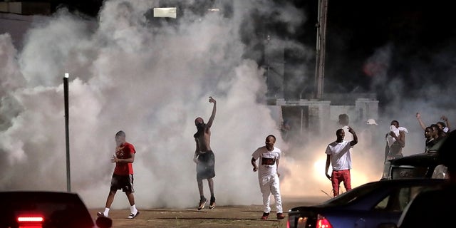 Frayser community residents mock the authorities as protesters take to the streets to protest the murder of a youth identified by family members as Brandon Webber by the United States Marshals earlier in the evening of Wednesday, June 12, 2019 in Memphis, Tennessee (Associated Press)