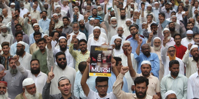 Supporters of the Pakistani religious party Jamaat-i-Islami, gather to offer a funeral prayer in absentia for ousted former Egyptian President Mohammed Morsi, in Karachi, Pakistan. Tuesday, June 18, 2019.