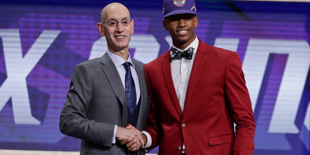 NBA Commissioner Adam Silver poses for photographs with Texas Tech's Jarrett Culver after the Phoenix Suns selected him as the sixth pick overall in the NBA basketball draft Thursday, June 20, 2019, in New York. (AP Photo/Julio Cortez)