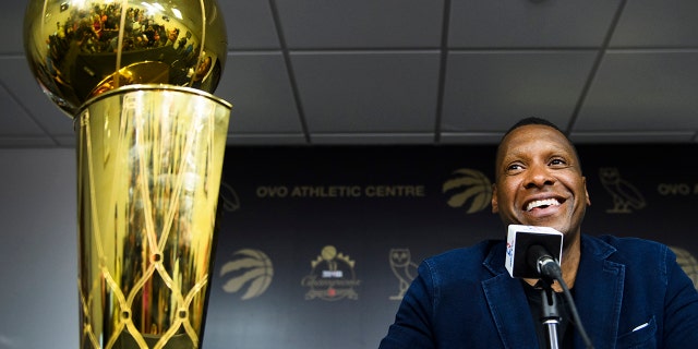 Toronto Raptors NBA basketball team president Masai Ujiri speaks to the media during an end-of-season press conference in Toronto, Tuesday, June 25, 2019. At left is the Larry O'Brien Trophy. (Nathan Denette/The Canadian Press via AP)