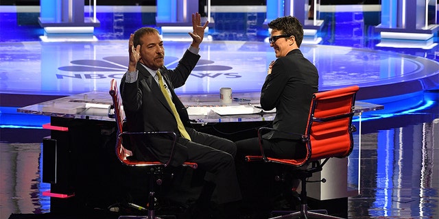 Moderators Chuck Todd (L) speaks to audience during a technical problem alongside Rachel Maddow. (JIM WATSON/AFP/Getty Images)